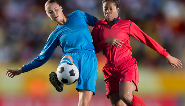 Female soccer players in action during a match. Composite image.